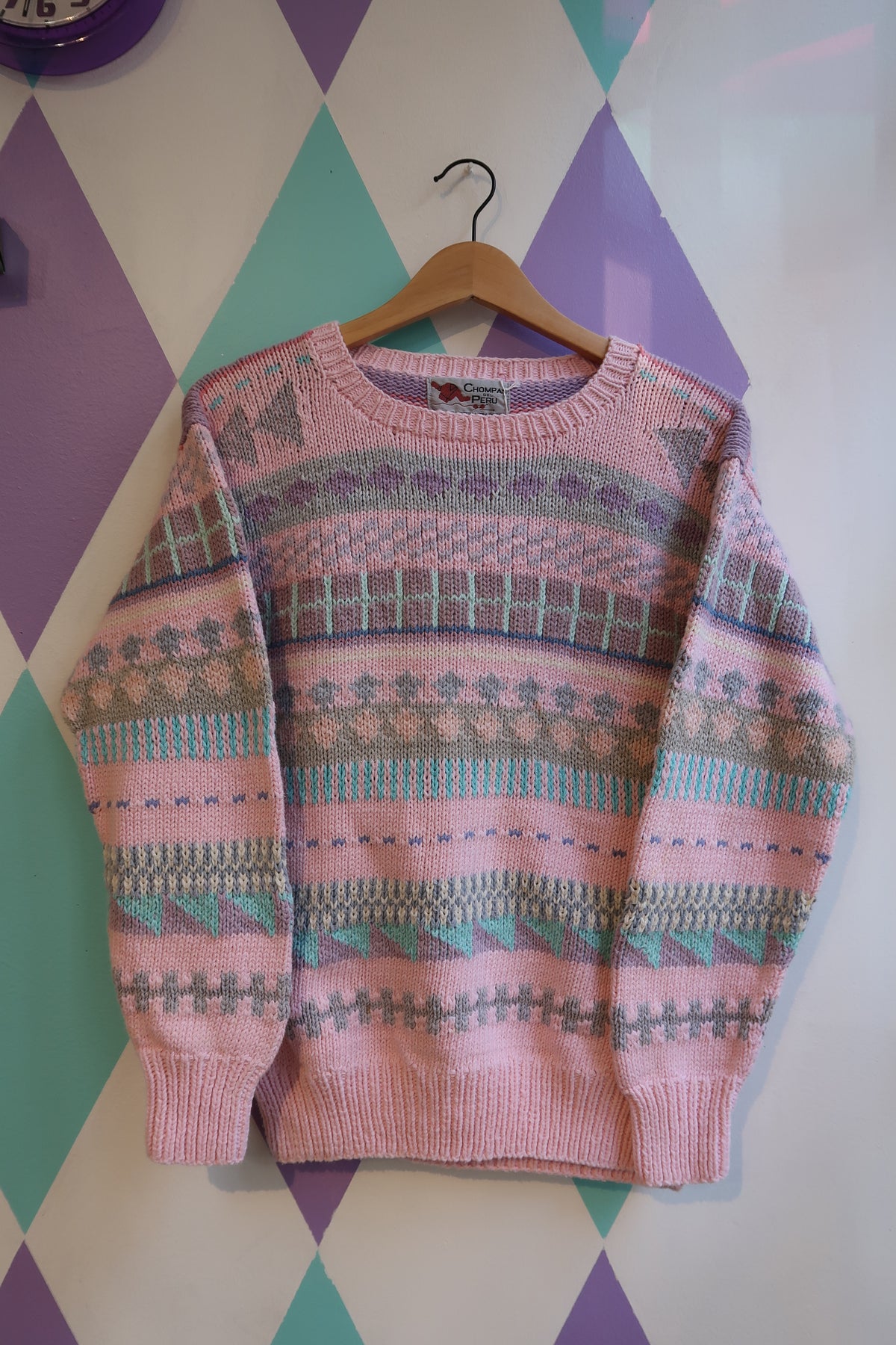 Pink Fair Isle sweater by Chompas Del Peru in vibrant knit with traditional patterns, styled with a cozy, casual look.