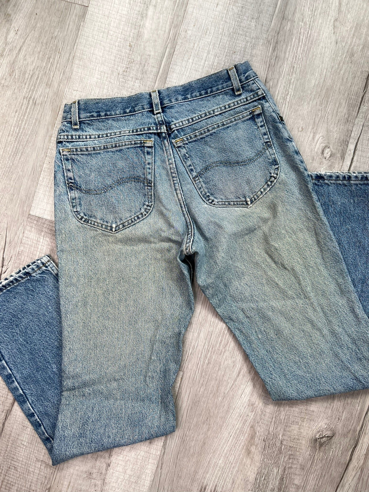 Men's light wash high-waisted mom jeans by Elektra Vintage, featuring classic fit and casual style, shown on a model.