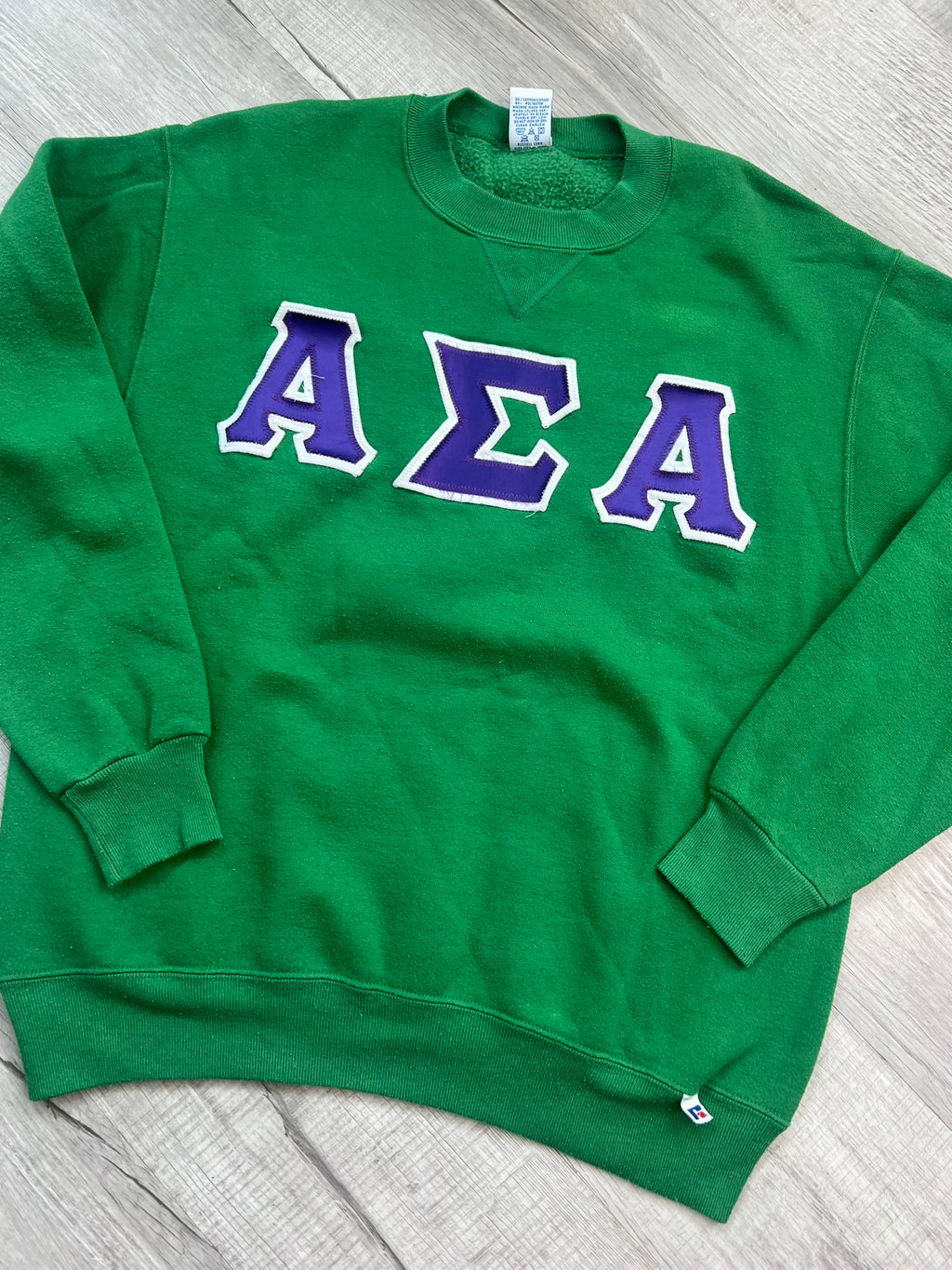 Vintage Alpha Sigma Alpha crewneck sweatshirt by Elektra Vintage, featuring retro design and soft fabric, displayed on a hanger.