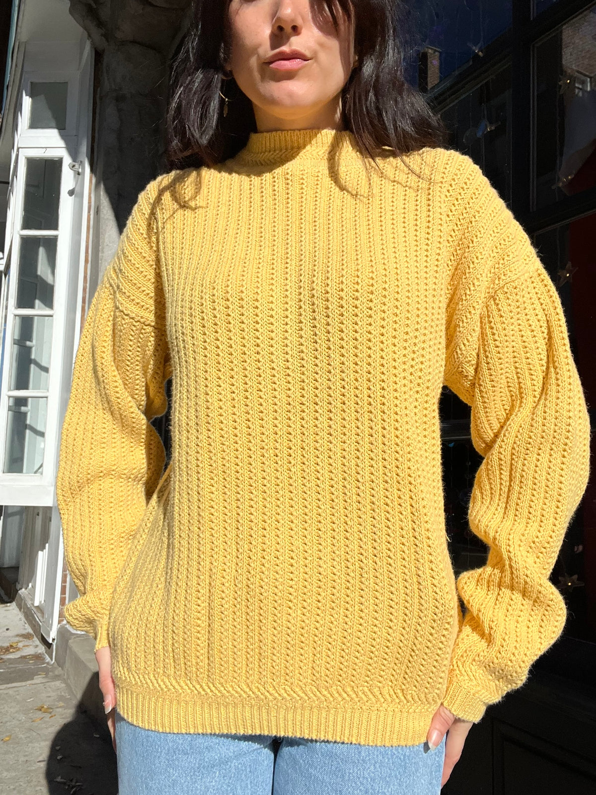Yellow oversized knit sweater by Elektra Vintage, showcasing a cozy, vintage-style design with a relaxed fit and textured knit fabric.