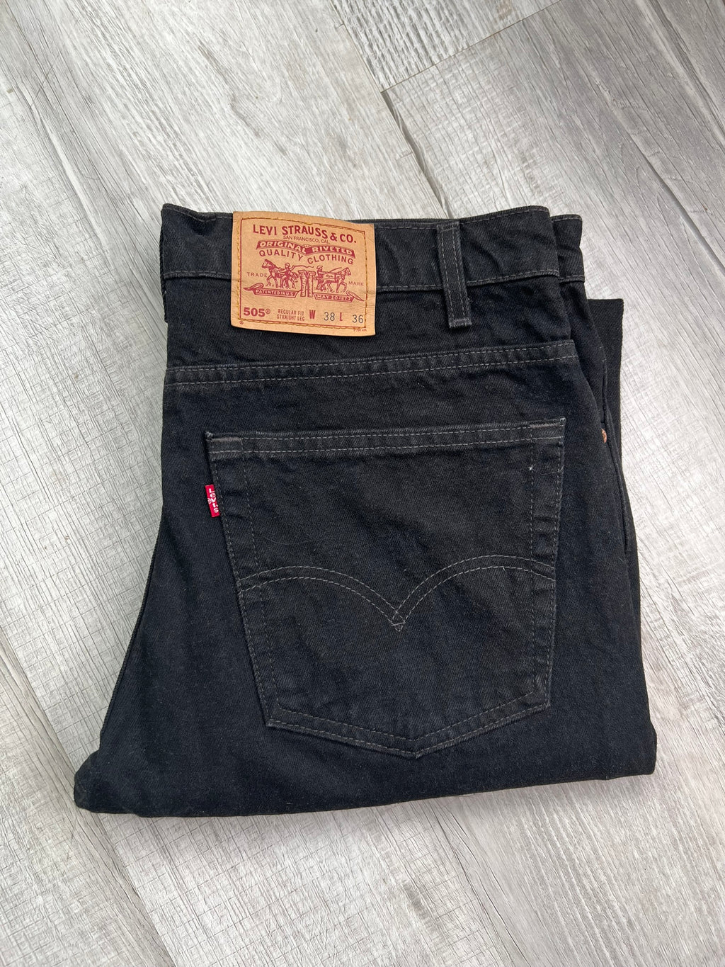 Men's Levi's 505 black denim straight fit jeans, Elektra Vintage brand, shown folded with classic five-pocket design.