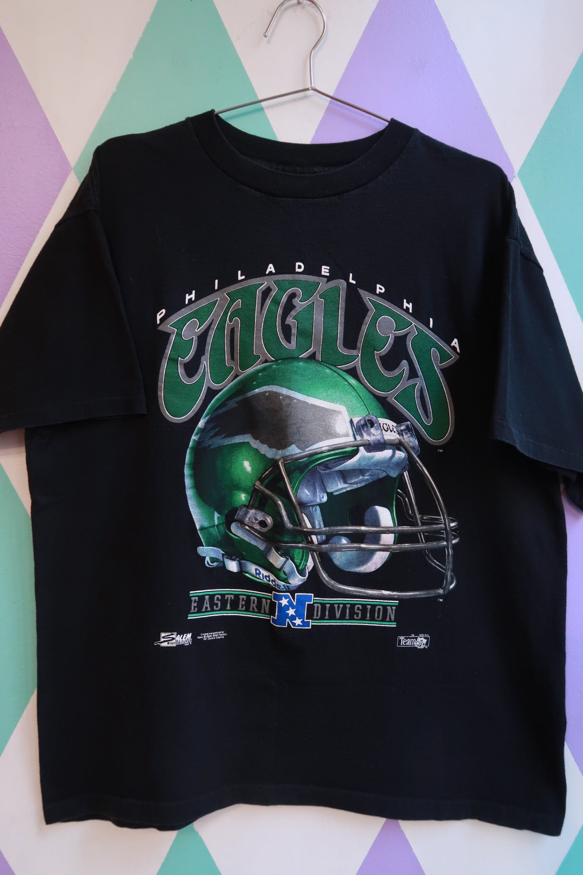 Men's black vintage 1991 Philadelphia Eagles football helmet graphic tee by Elektra Vintage, featuring classic NFL football design.