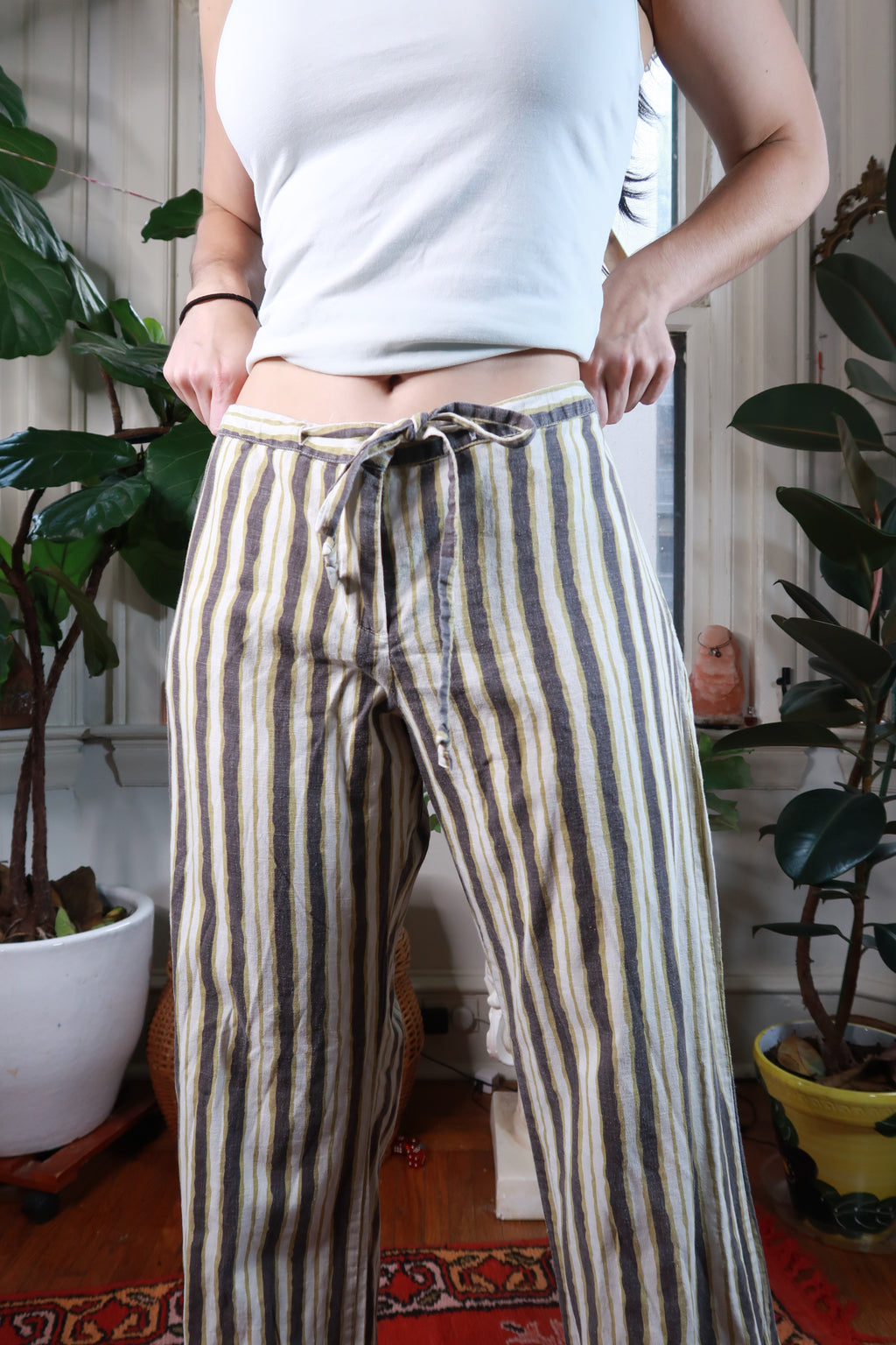 Vintage 2000s black mustard yellow striped drawstring low-rise women's pants by Elektra Vintage, styled with casual fit and bold pattern.