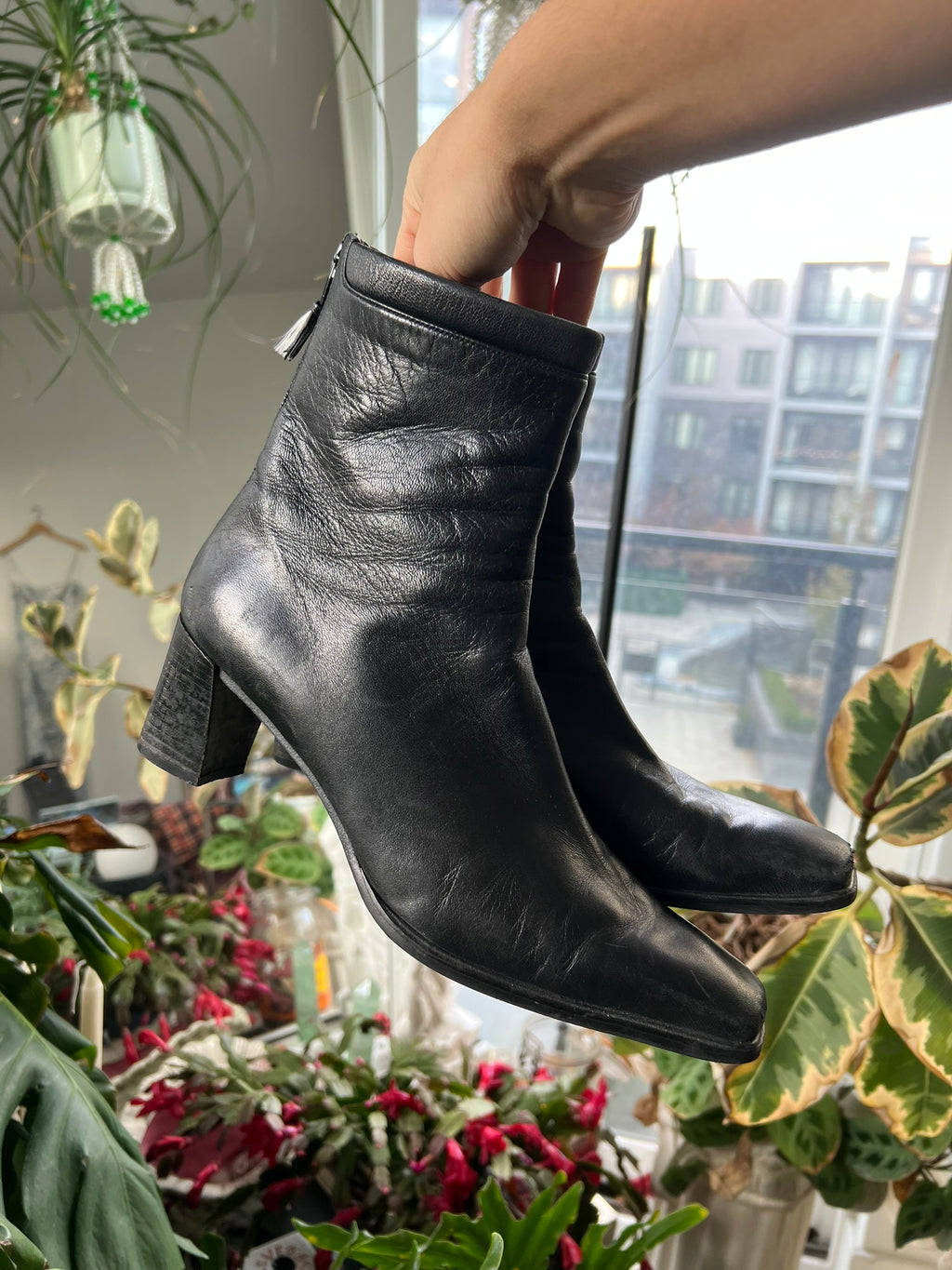 Vintage Stuart Weitzman square toe boots in black leather, displayed on a neutral background with stylish detailing.