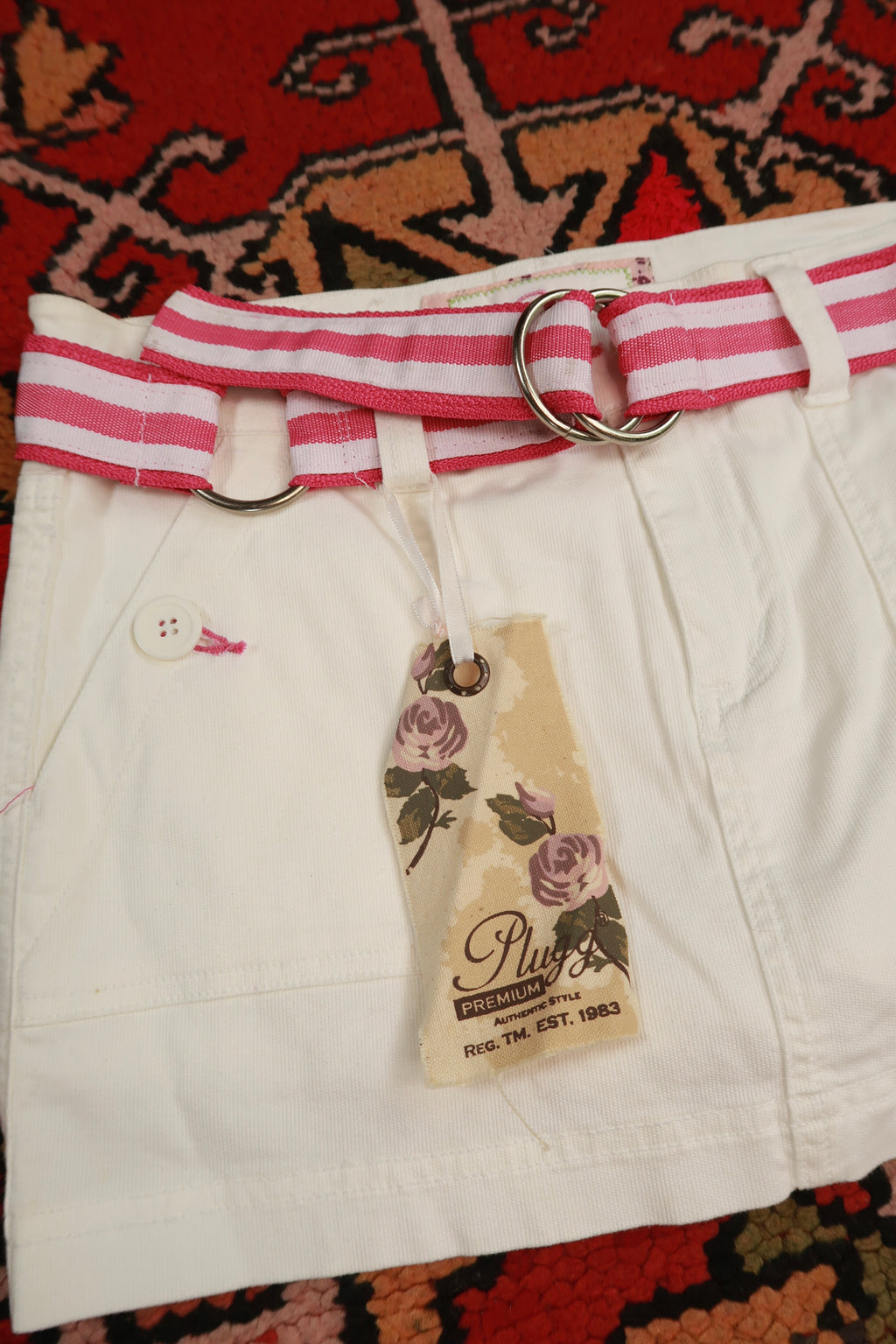 Vintage Elektra Y2K white denim mini skirt with pink stripe belt, stylish and classic for retro-inspired fashion.