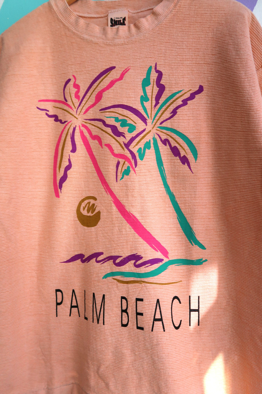 Vintage heavy cotton Coral Palm Beach graphic tee by Elektra Vintage featuring a colorful palm tree design on a coral background.
