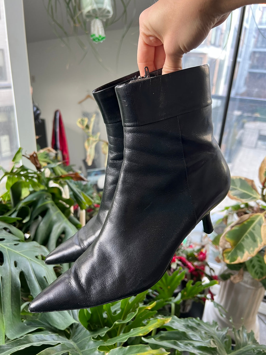 Vintage black leather pointed toe boots by Elektra Vintage, showcasing sleek design and stylish craftsmanship.