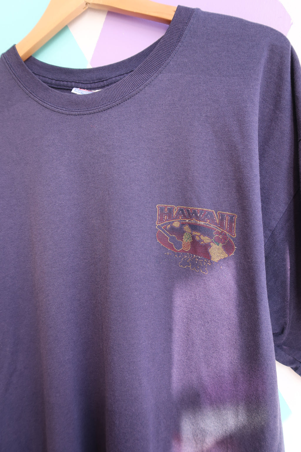 Vintage purple faded Hawaii graphic T-shirt by Elektra Vintage, featuring a retro tropical island design on soft cotton fabric.