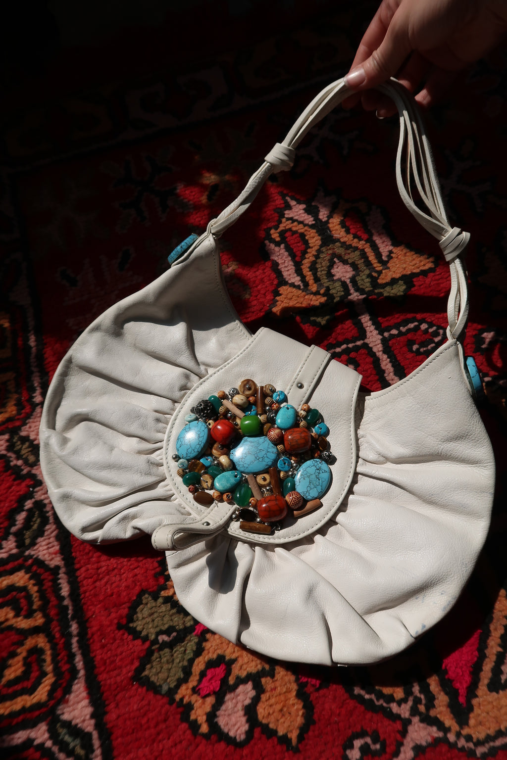 Vintage white boho hobo bag with colorful beaded turquoise embellishments by Elektra Vintage, showcasing its textured fabric and decorative details.