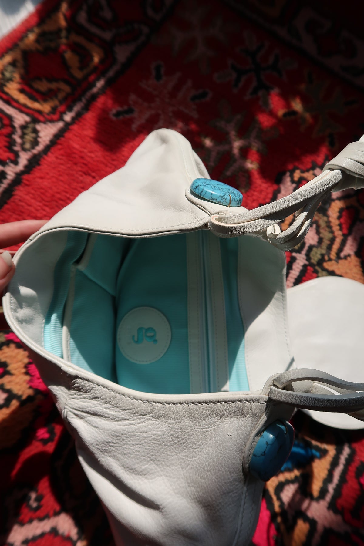 Vintage white boho hobo bag by Elektra Vintage with colorful beaded turquoise embellishments and a relaxed, stylish design.