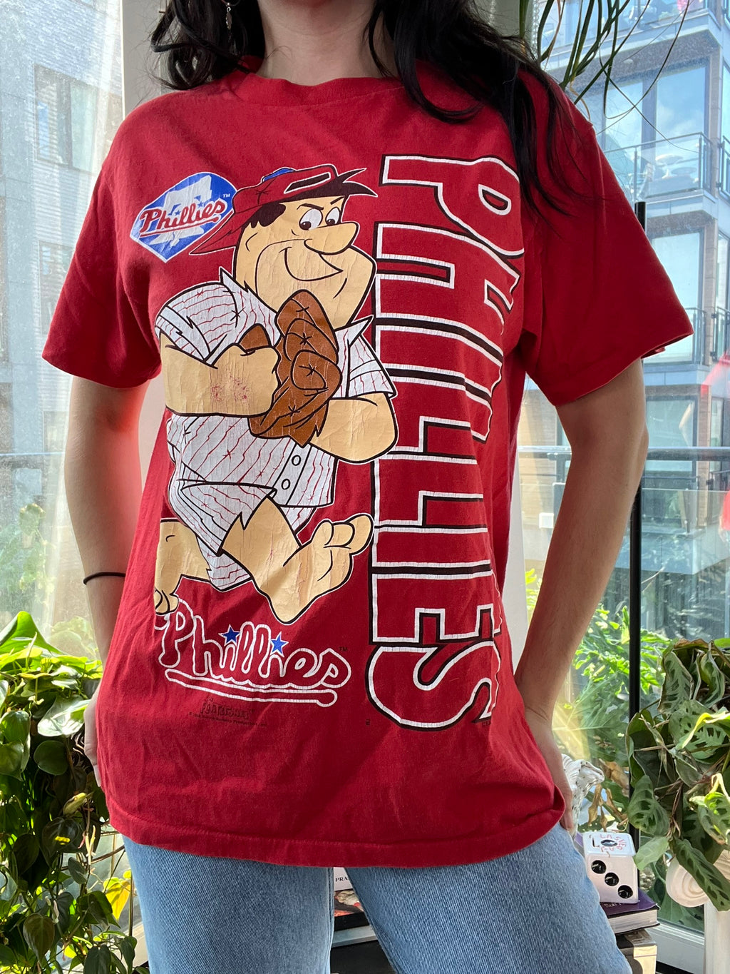 90s vintage Phillies baseball T-shirt featuring Flintstones graphic from Elektra Vintage, with colorful cartoon print on soft cotton fabric.