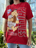 90s vintage Phillies baseball graphic tee featuring Flintstones design by Elektra Vintage, showing colorful cartoon print on soft cotton fabric.