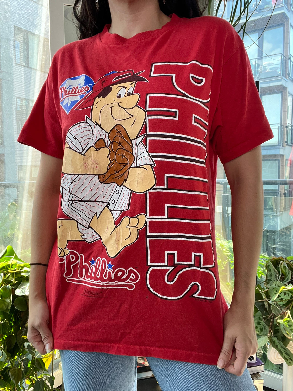 90s vintage Phillies baseball graphic tee featuring Flintstones design by Elektra Vintage, showing colorful cartoon print on soft cotton fabric.
