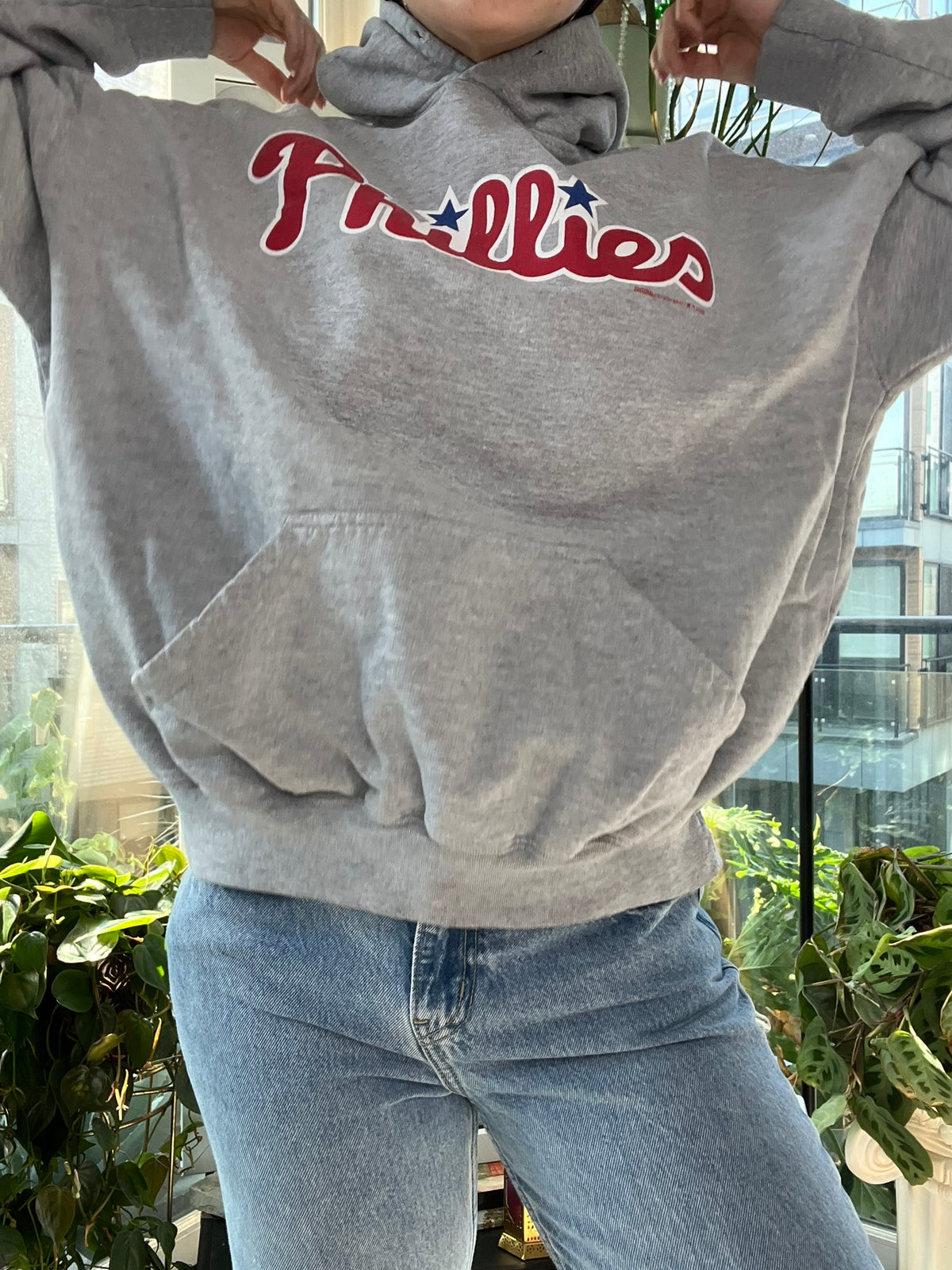 2000s Phillies hoodie by Elektra Vintage, featuring team logo and vintage design, displayed on a hanger.