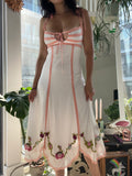 Vintage white Betsey Johnson floral dress by Elektra Vintage, featuring a fitted bodice and flowing skirt.