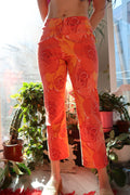 Vintage 2000s Cache orange rose patterned women's bottoms by Elektra Vintage, featuring a bold floral design and tailored fit.