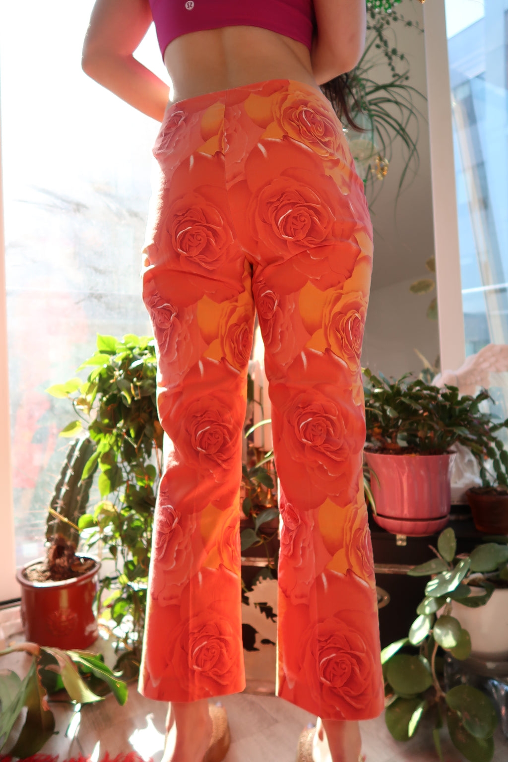 Vintage 2000s Cache orange rose patterned women's pants by Elektra Vintage, featuring bold floral print and relaxed fit.