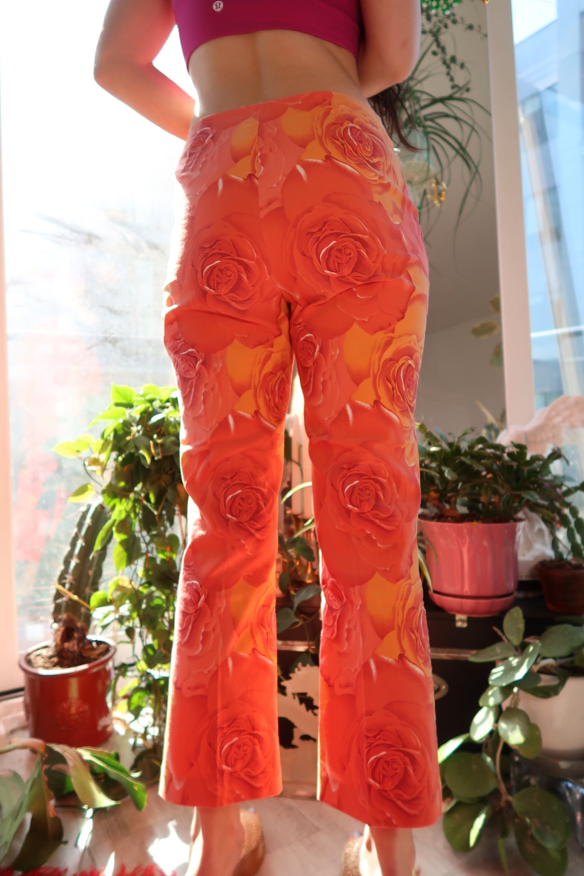Vintage 2000s Cache orange rose patterned women's pants by Elektra Vintage, featuring bold floral print and relaxed fit.
