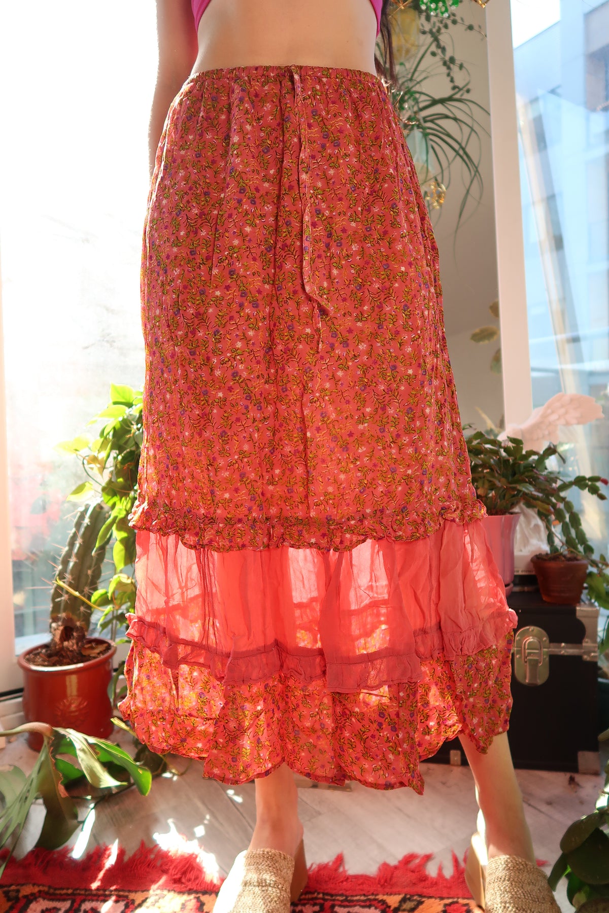 Vintage pink floral tiered midi skirt by Elektra Vintage, featuring flowing fabric and layered design.