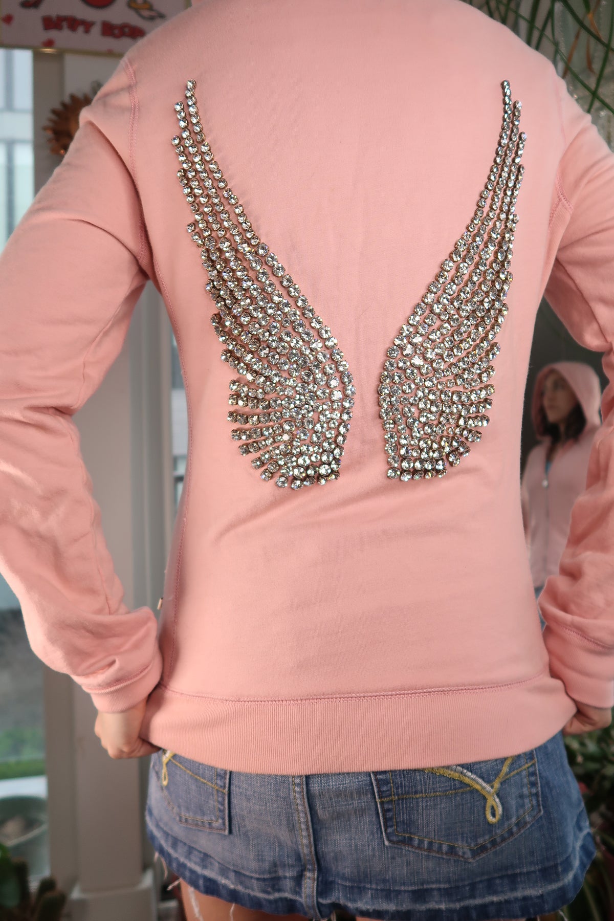 Women's 2000s rhinestone angel wings hoodie by Elektra Vintage, featuring sparkly wing design on a retro-style top.