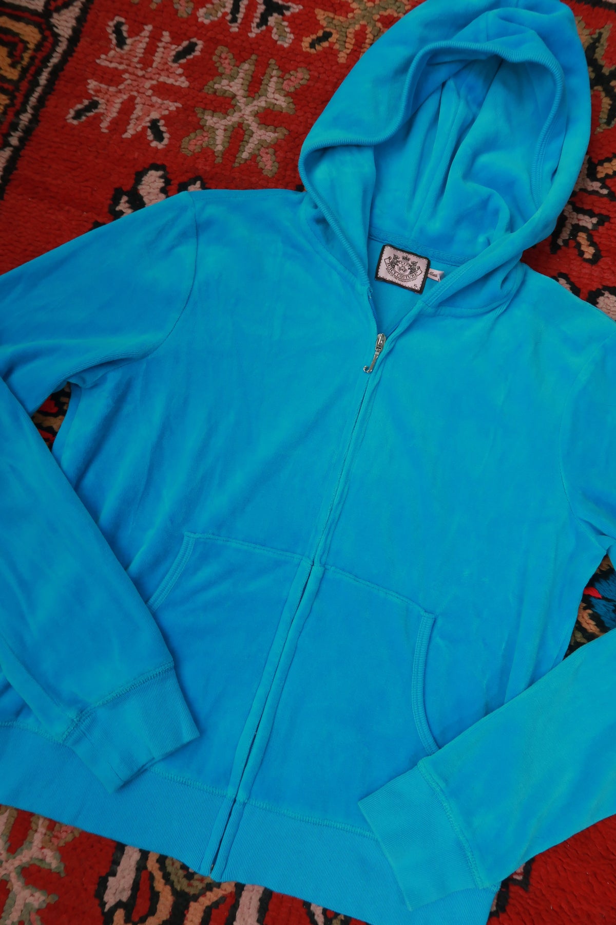 Vintage turquoise velour zip-up hoodie for women by Juicy Couture, featuring a classic Y2K style and Elektra Vintage branding.