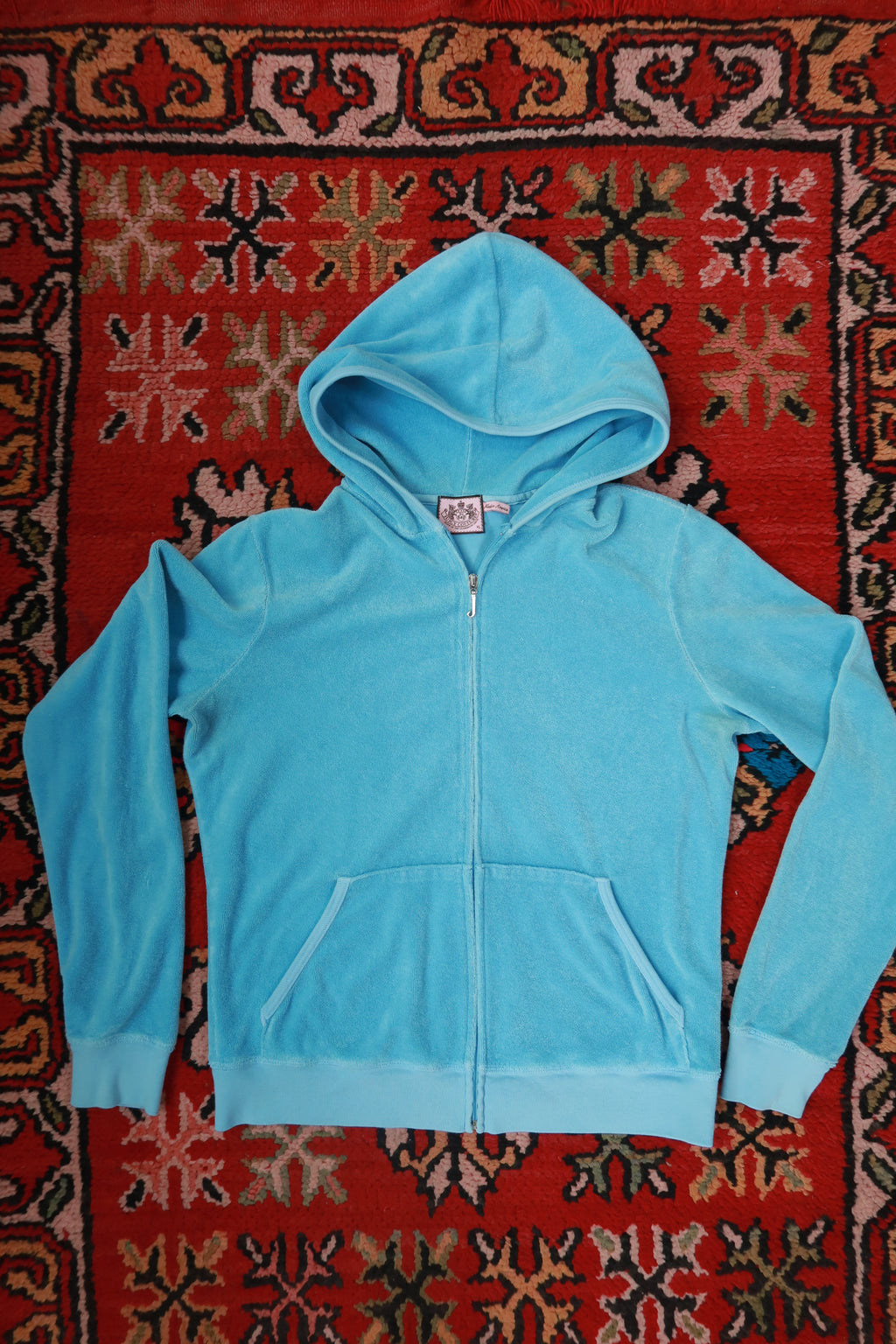 Vintage Baby Blue Juicy Couture terry cloth zip-up hoodie for women, by Elektra Vintage, displayed on a hanger.