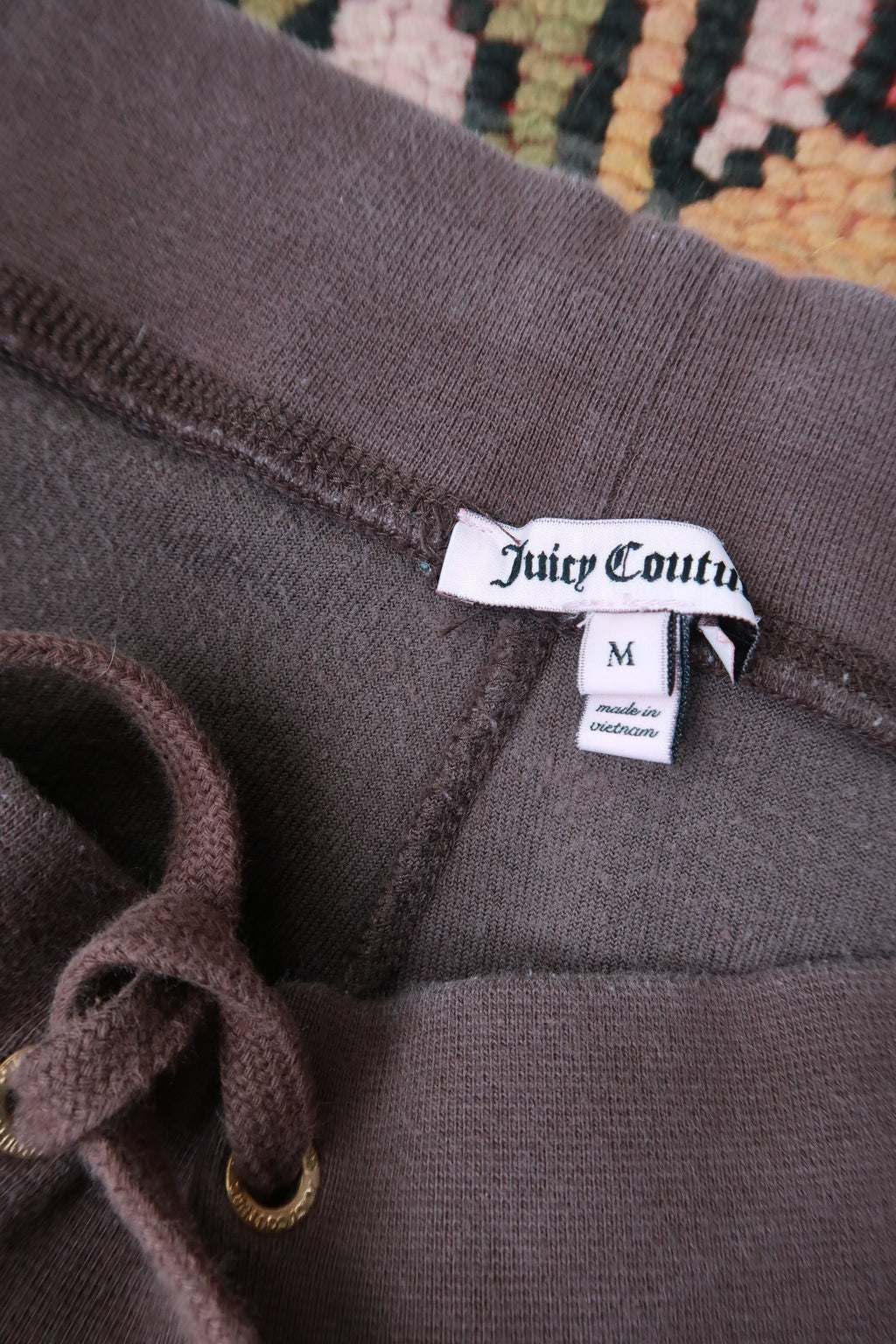 Chocolate brown Juicy Couture velour lounge pants for women, featuring a relaxed fit and elastic waistband, by Elektra Vintage.