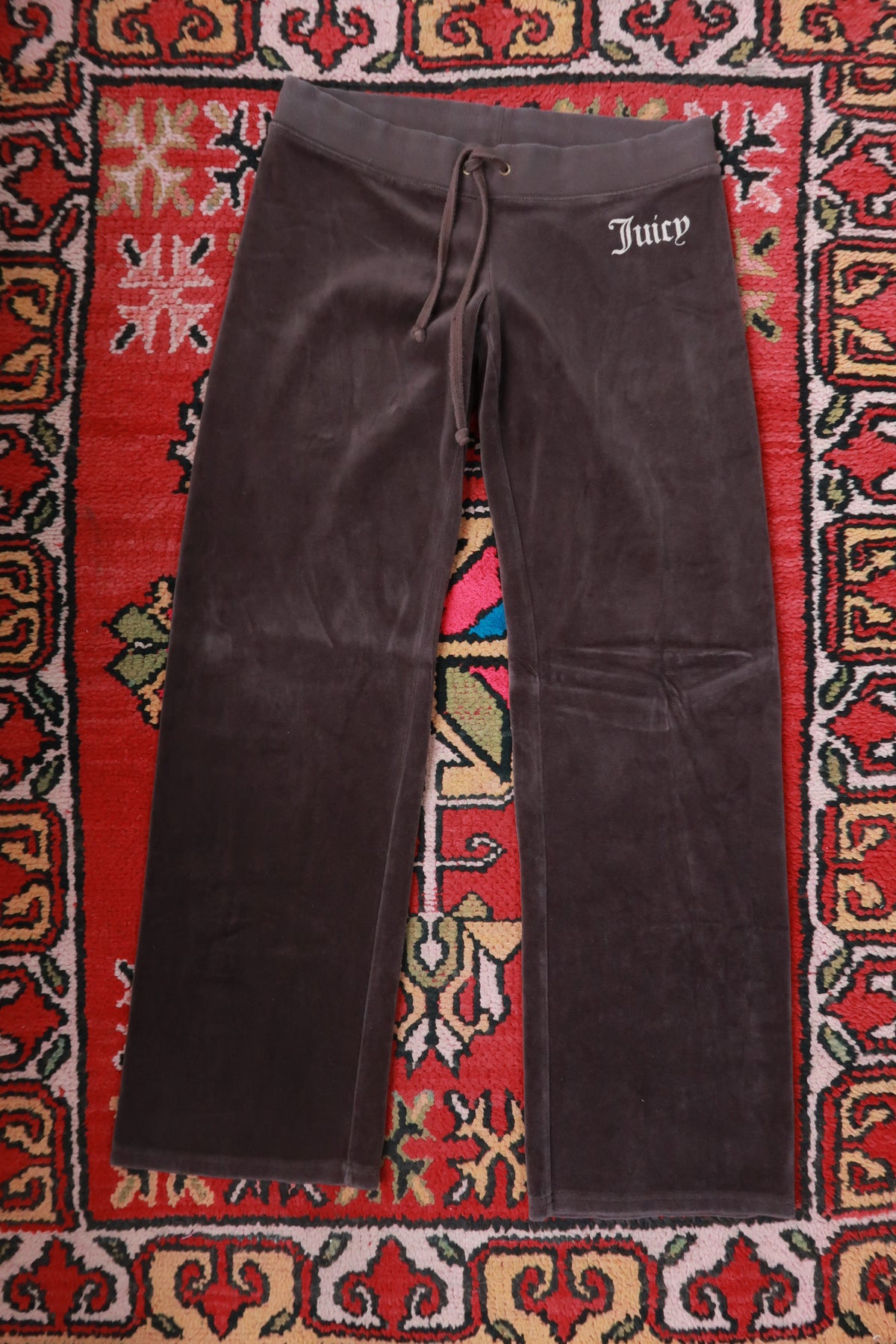 Chocolate brown Juicy Couture velour lounge pants for women by Elektra Vintage, shown laid flat with a relaxed fit.