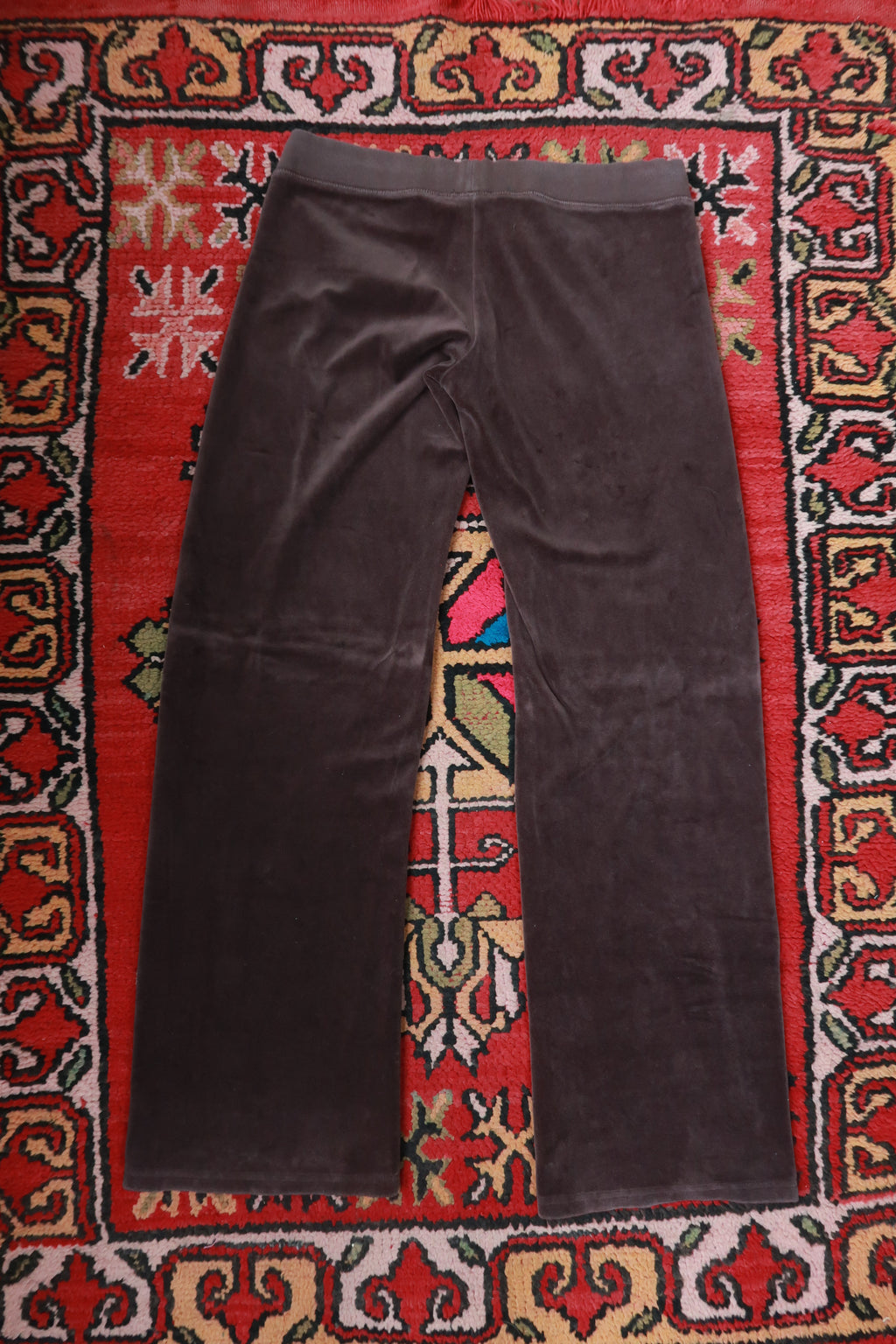 Chocolate brown Juicy Couture velour lounge pants for women, featuring a relaxed fit and elastic waistband, from Elektra Vintage.
