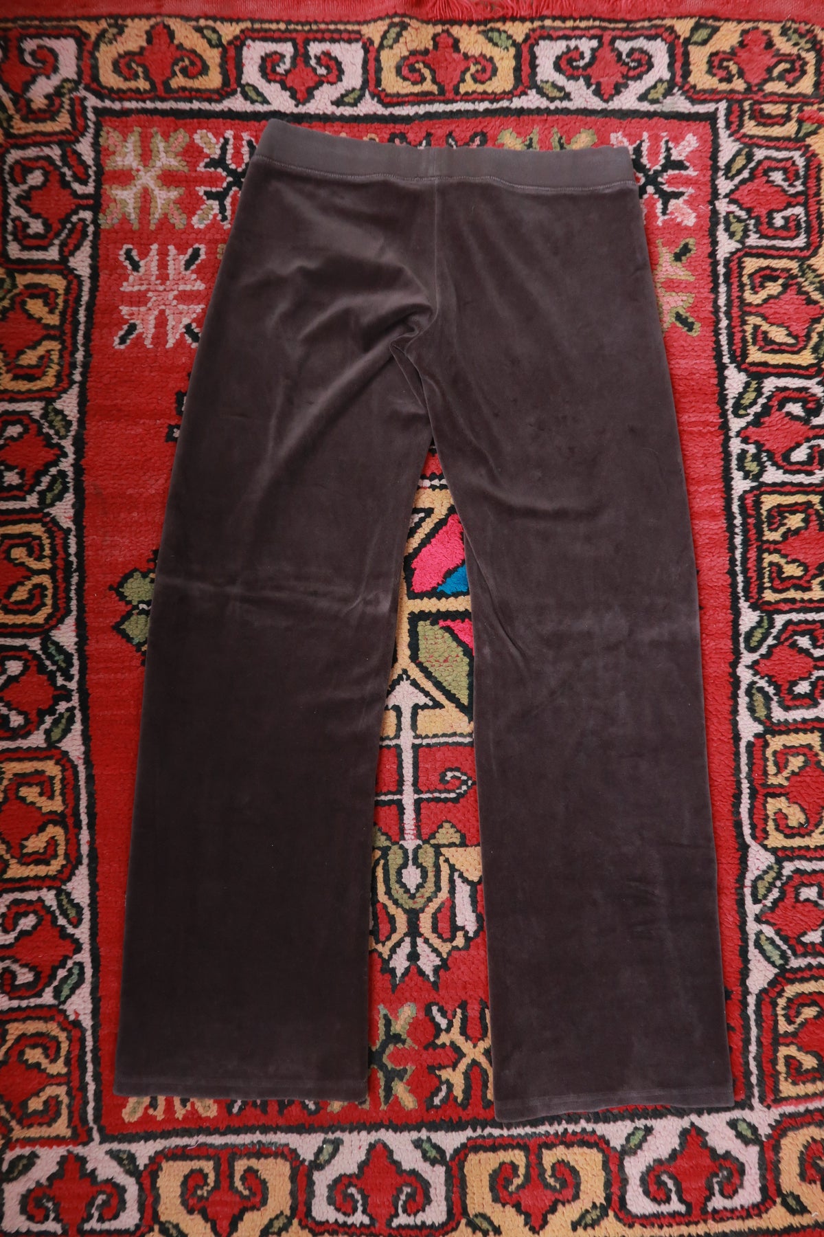 Chocolate brown Juicy Couture velour lounge pants for women, featuring a relaxed fit and elastic waistband, from Elektra Vintage.