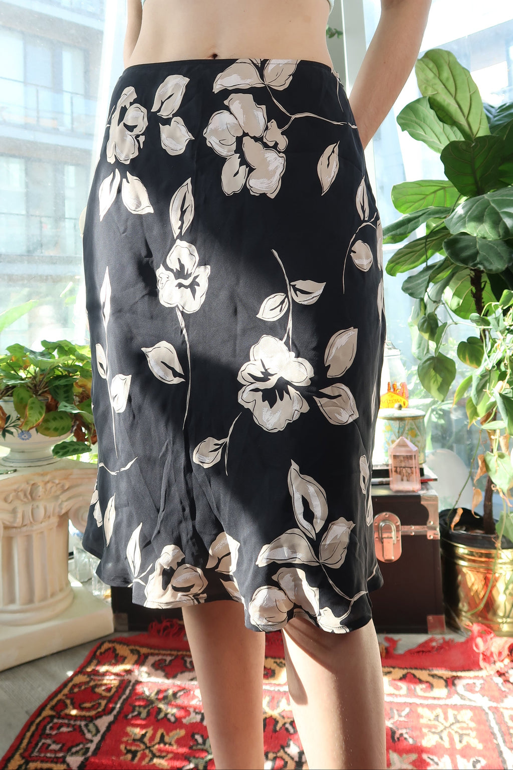 Vintage Elektra Vintage black floral skirt with a bias cut, showcasing a flowy design and elegant silk fabric.