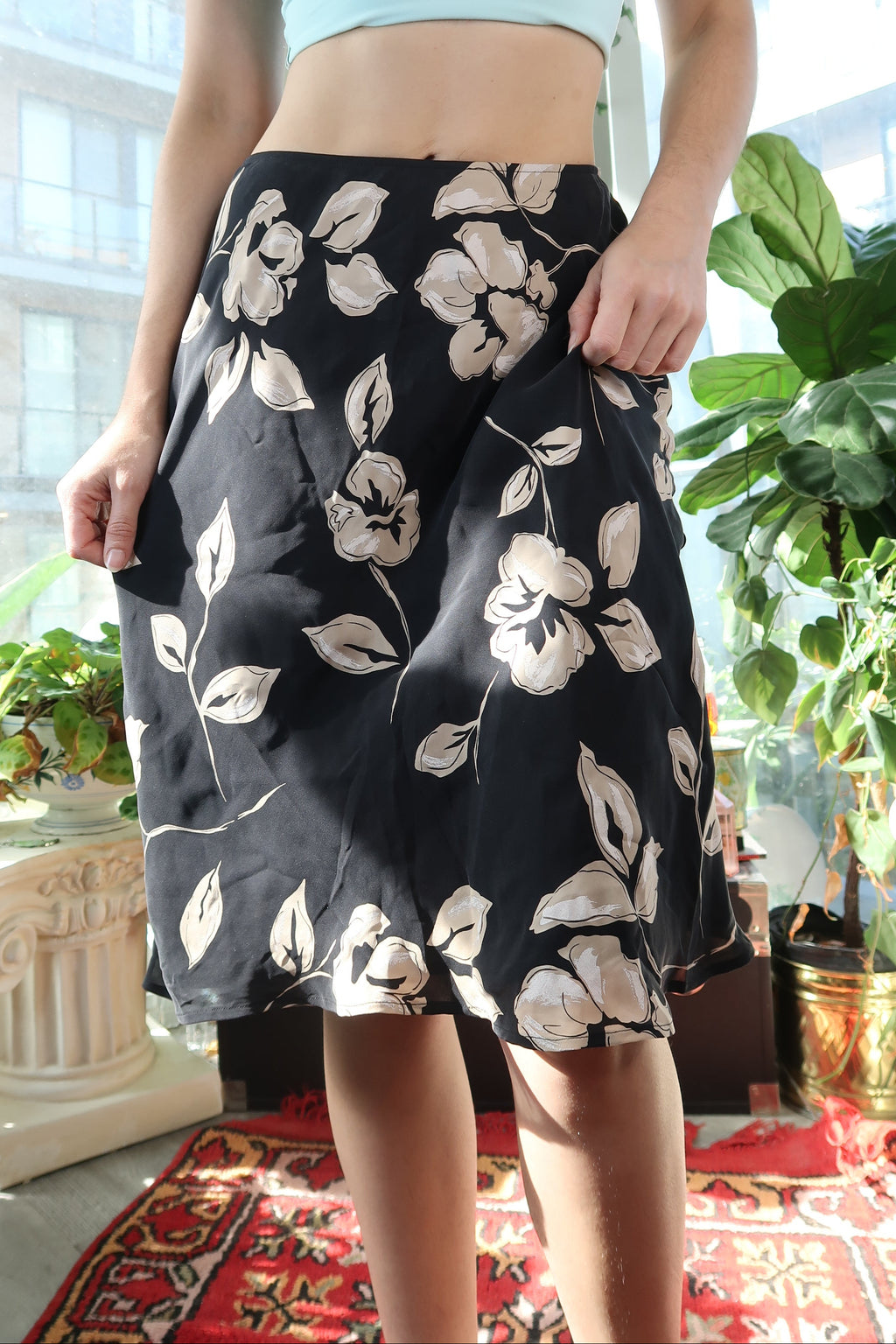 Flowy black floral skirt by Elektra Vintage, made of 100% silk with a bias cut design.