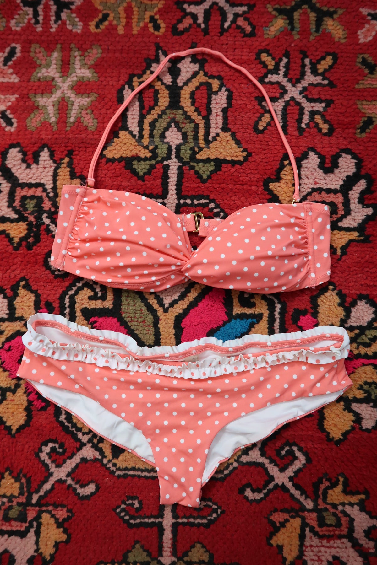 Vintage 2000s Victoria’s Secret polka dot bikini set by Elektra Vintage in coral and white with ruffle details, displayed on a swimsuit mannequin.