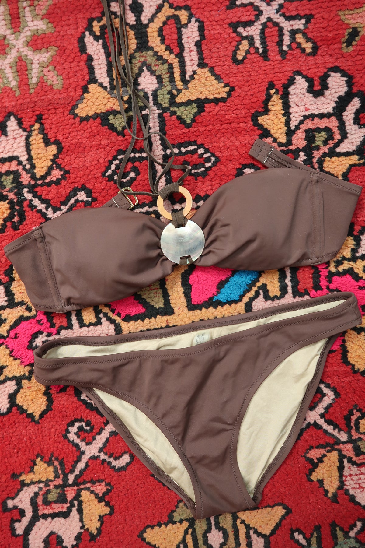 Vintage 2000s Victoria’s Secret brown bandeau bikini with Y2K style and abalone shell detail, displayed on a neutral background.