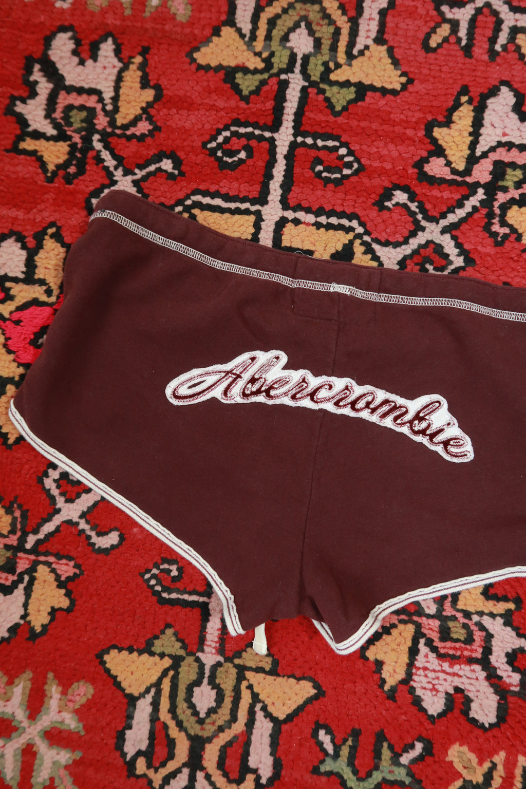 Vintage Y2K burgundy Dolphin shorts by Abercrombie & Fitch, women's bottoms with a retro style, shown on a model.