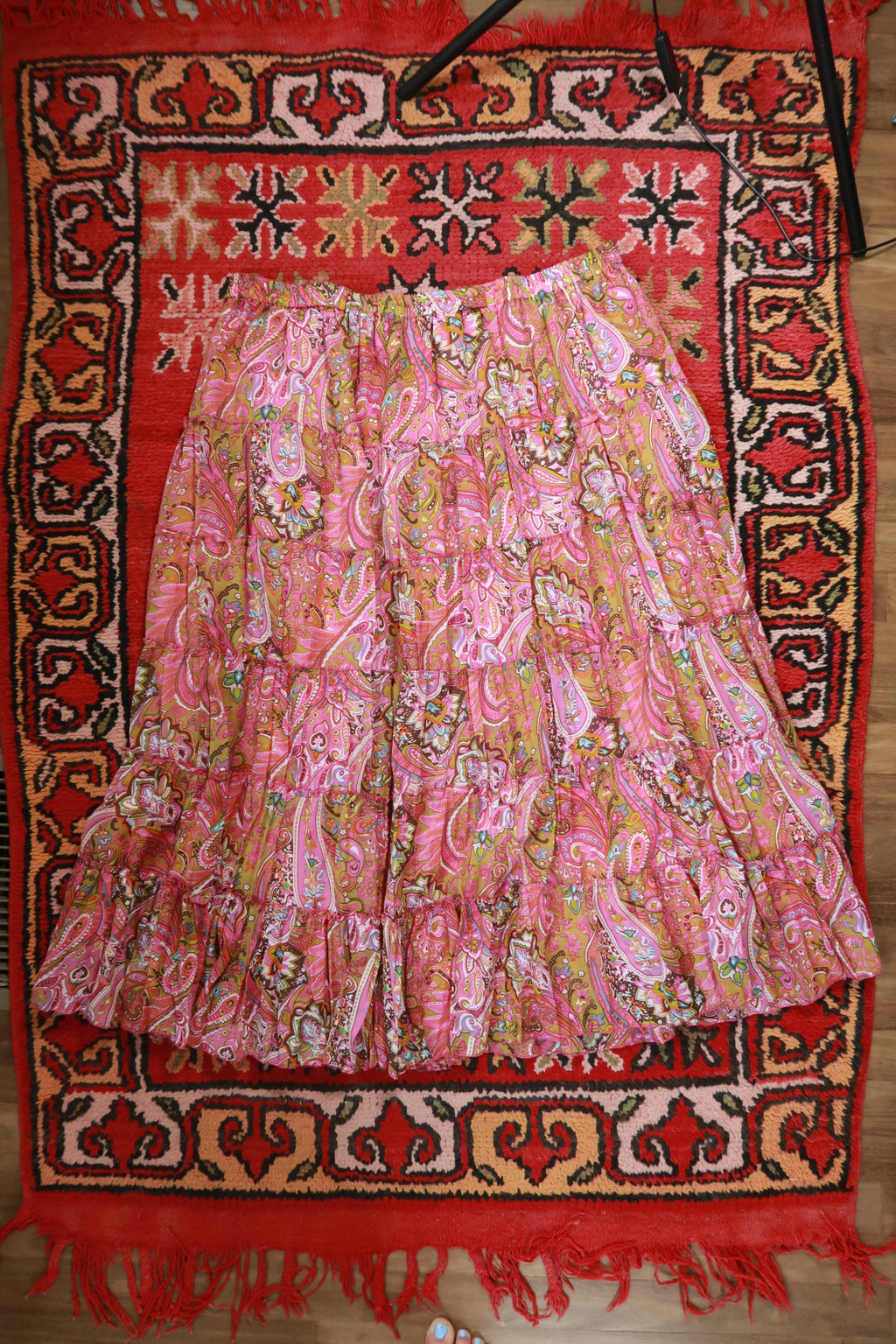 Vintage pink paisley boho midi skirt by Elektra Vintage with tiered design and flowing fabric, perfect for bohemian style.