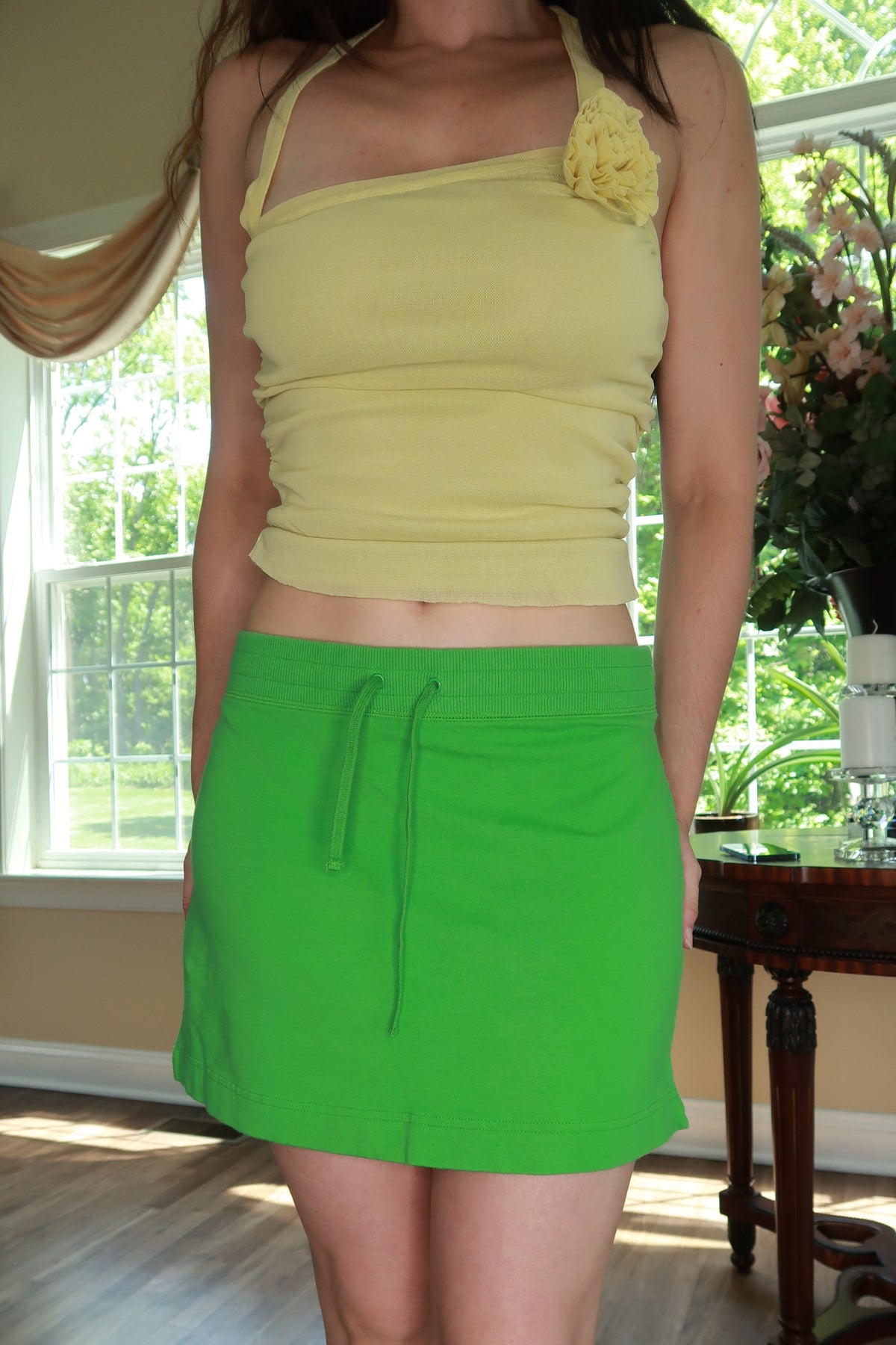 Vintage Y2K Lime Green Mini Skirt by Elektra Vintage, showing the bright mini skirt with a fitted waist and zipper detail.