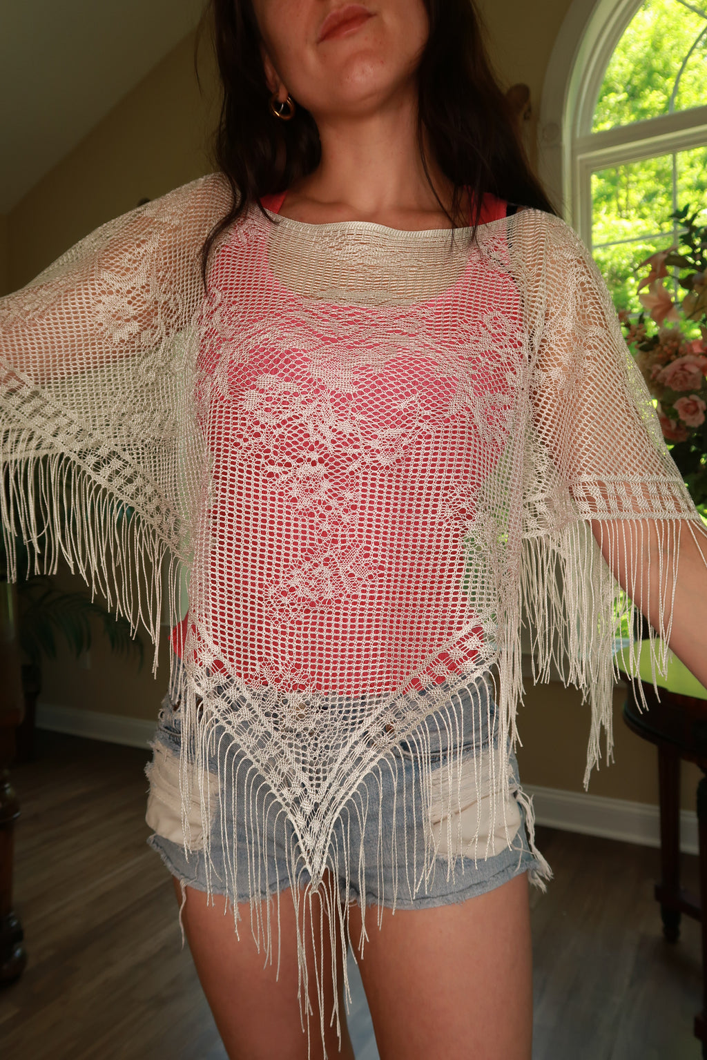 White crochet fringe poncho top for women by Elektra Vintage, styled with intricate crochet details and flowing fringe.