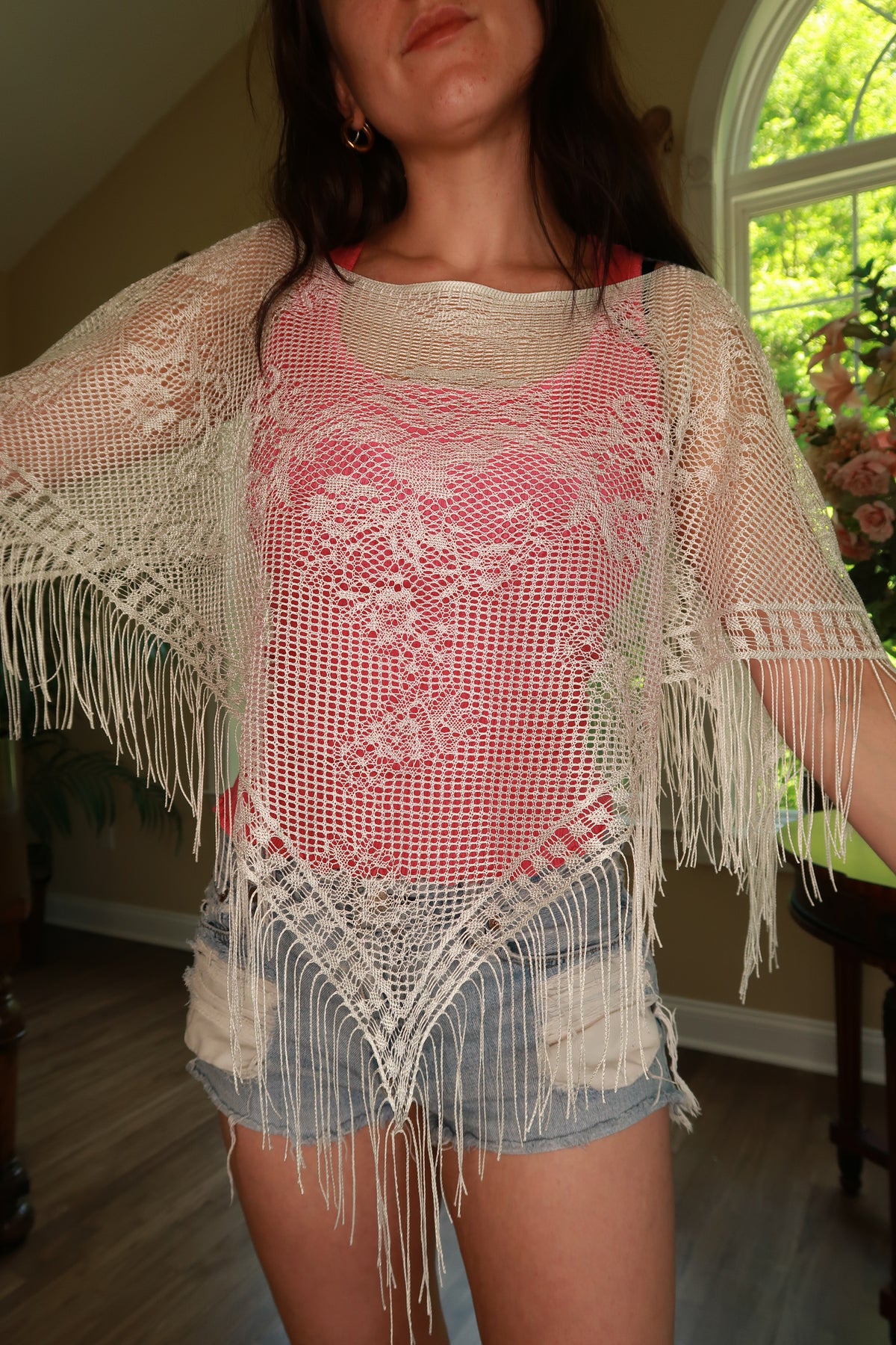 White crochet fringe poncho top for women by Elektra Vintage, styled with intricate crochet details and flowing fringe.