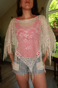 Elektra Vintage women's white crochet fringe poncho top with intricate detailing and boho style, draped on a mannequin.