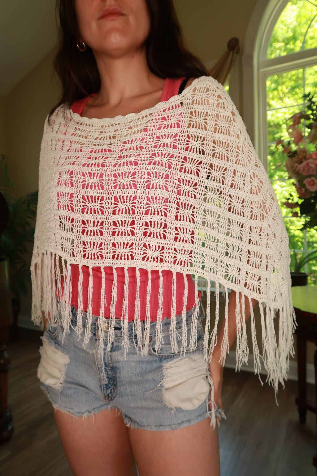 White crochet fringe poncho for women from Elektra Vintage, vintage 2000s style, featuring intricate crochet detailing and fringe trim.