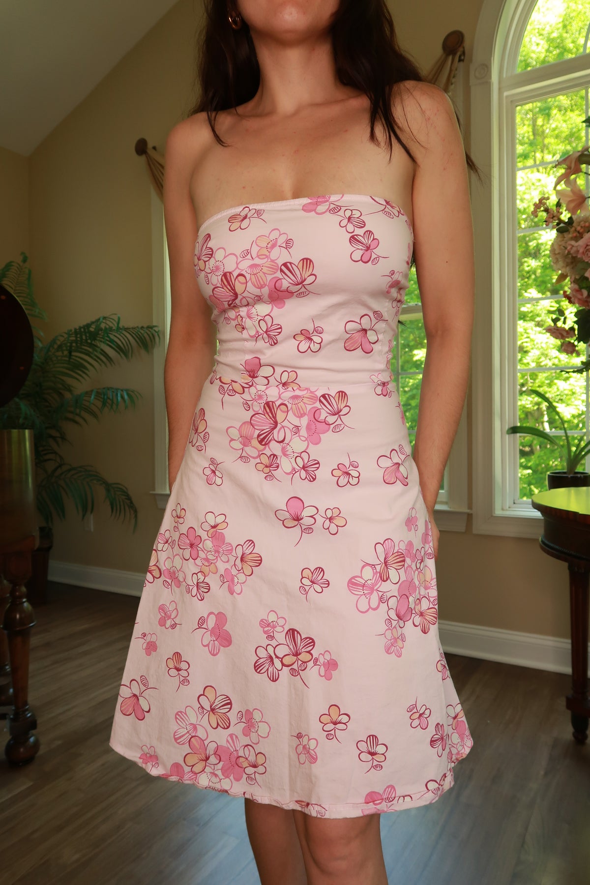 Vintage pink floral strapless dress by Elektra Vintage, featuring a fitted bodice and flowing skirt, perfect for 2000s-inspired fashion.