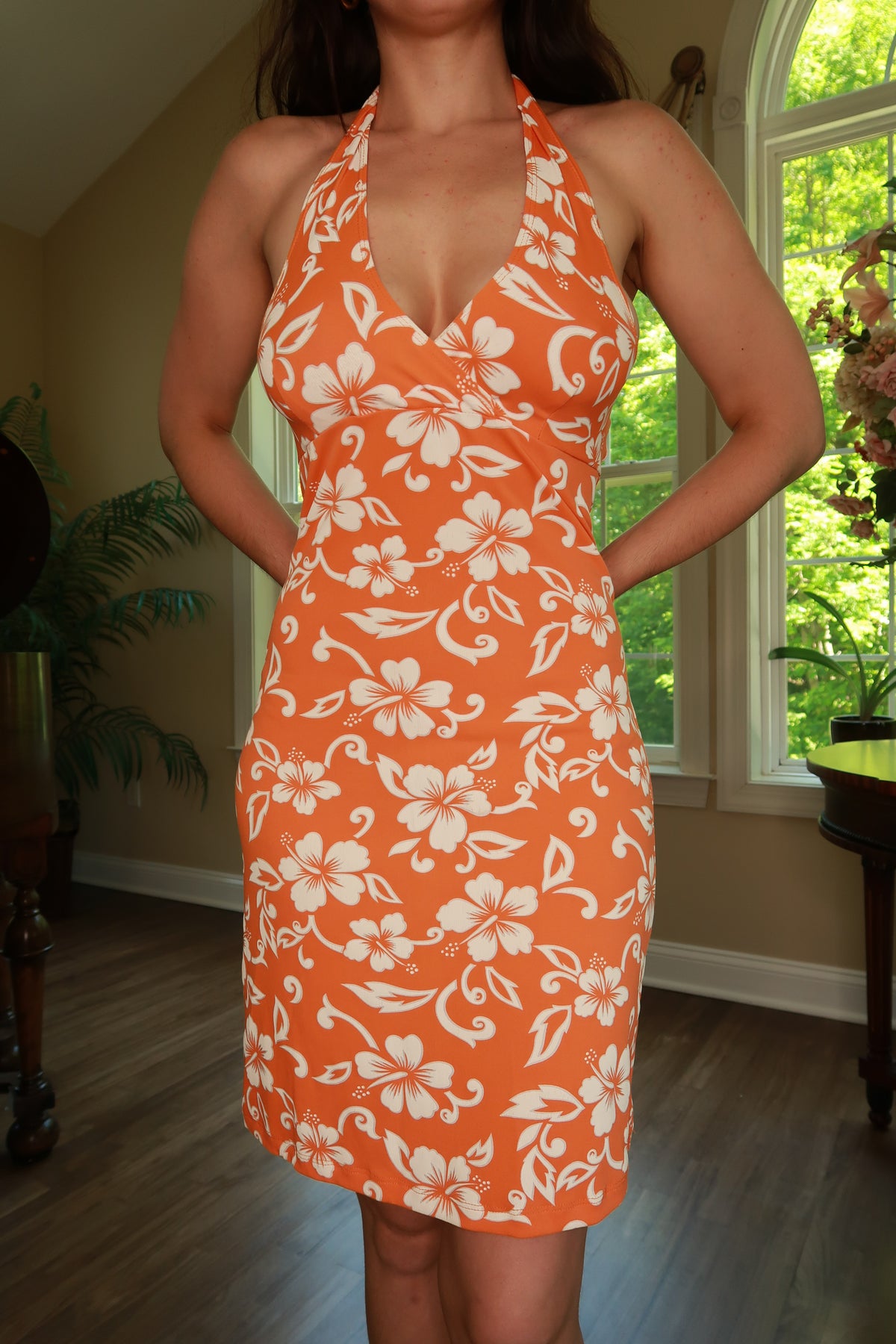 Vintage 2000s orange Hawaiian halter dress by Elektra Vintage with tropical floral pattern and flowing fabric.