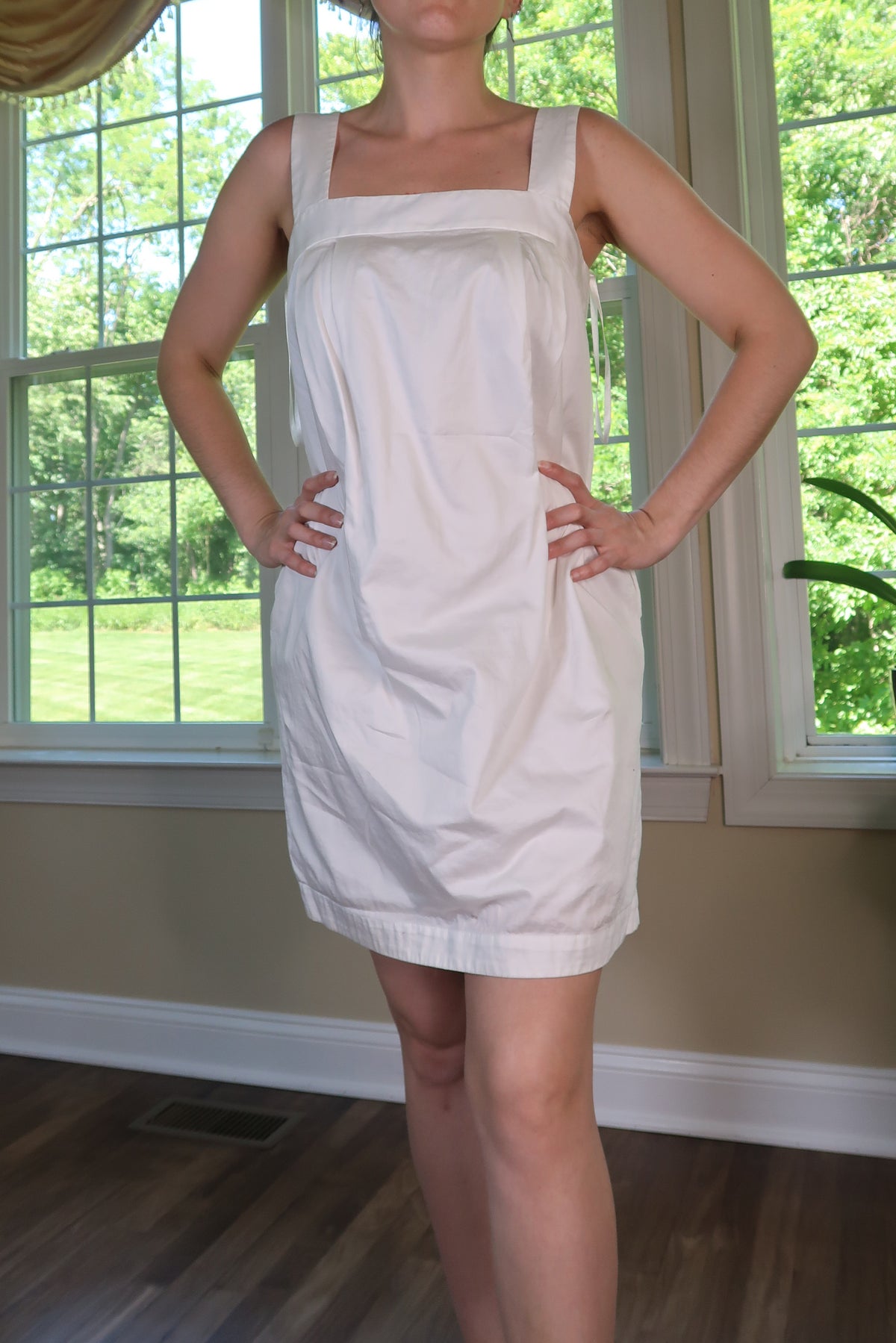Vintage 2000s BCBG white shift mini dress by Elektra Vintage, featuring a classic sleeveless design and simple silhouette.