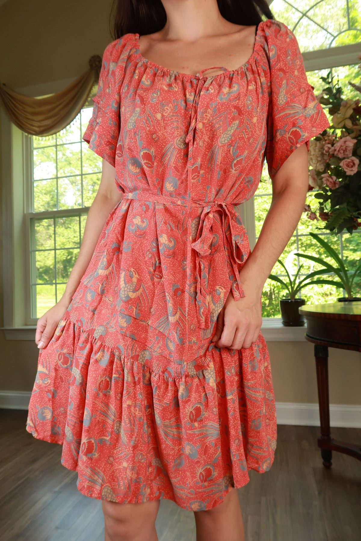 Vintage 2000s coral red silk paisley peasant tiered mini dress by Elektra Vintage displayed on a hanger.