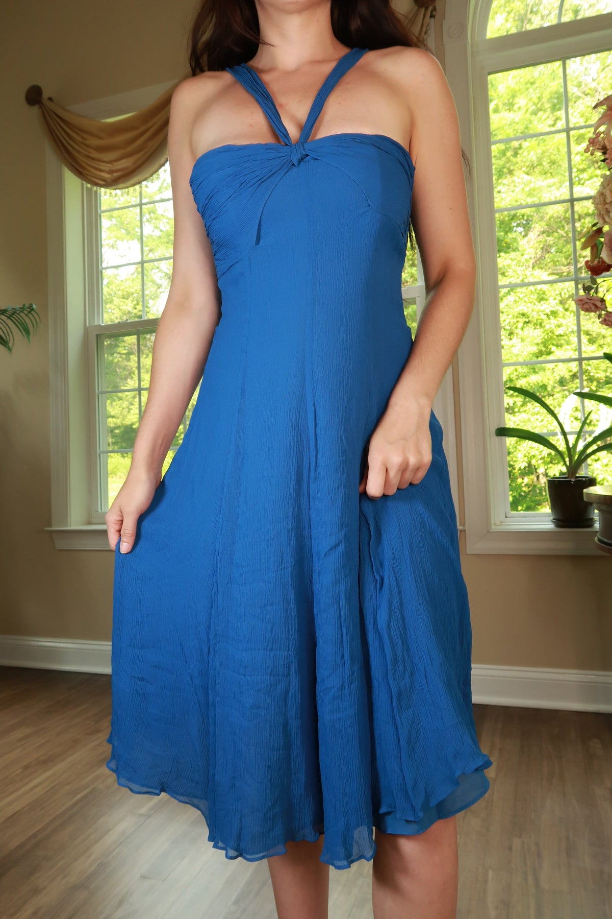 Vintage 2000s silk blue halter midi dress by Elektra Vintage displayed on a hanger with a plain background.
