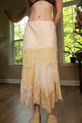 Vintage patchwork lace maxi skirt by Elektra Vintage with intricate lace details and flowing silhouette, shown on a model.