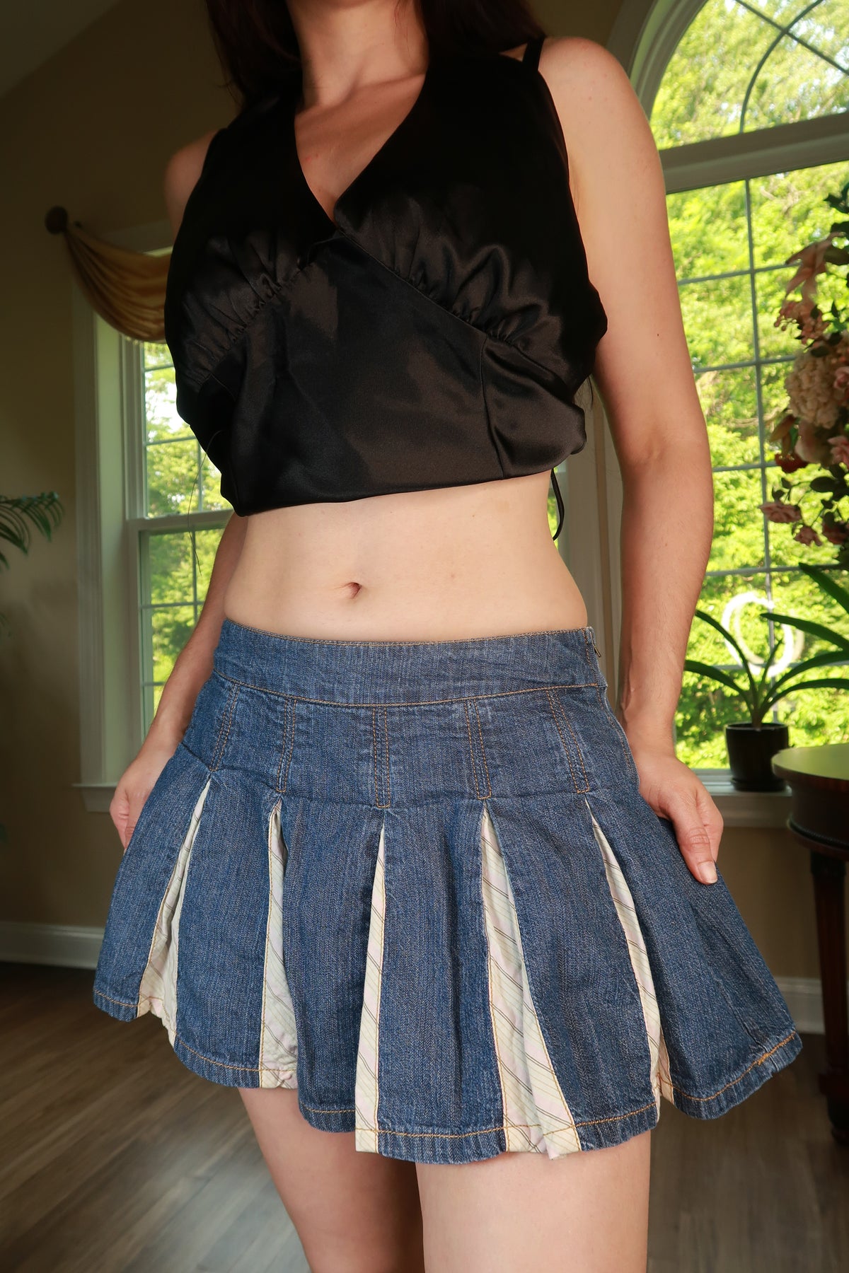 Vintage 2000s DKNY pleated denim mini skirt from Elektra Vintage, featuring classic denim fabric and a stylish pleated design.