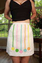 Load image into Gallery viewer, Vintage white Mod A-line mini skirt by Elektra Vintage with pastel ribbon appliqué, featuring a high waist and classic silhouette.
