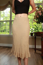 Load image into Gallery viewer, Beige vintage Y2K silk midi skirt with embroidered ruffle hem from Elektra Vintage, showcasing detailed floral embroidery and flowy fabric.
